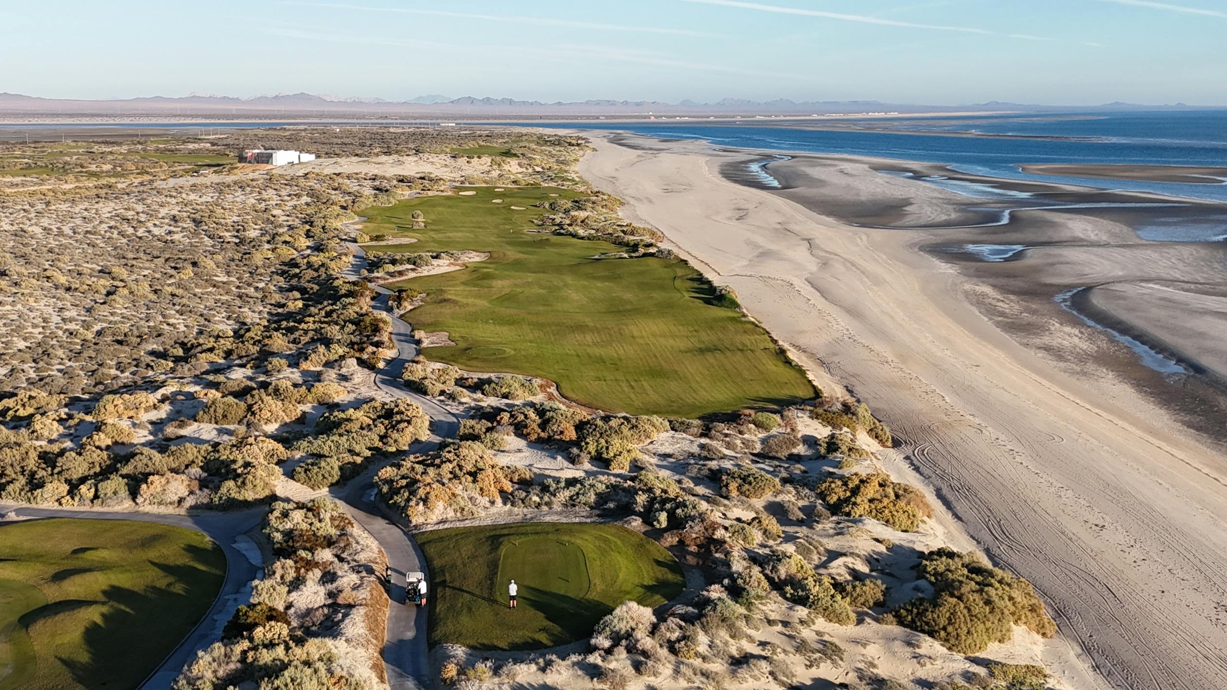 Links golf course beside sandy beach and dunes